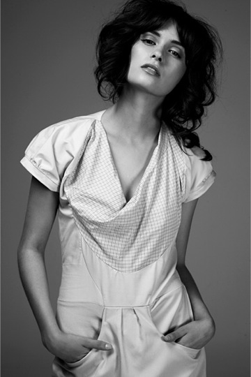 A model poses nonchalantly with her hands in her pockets, in a dress by Nicola DeMain.